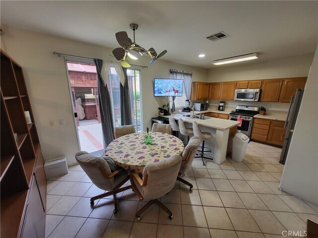 dining area with ceiling fan and light tile patterned floors