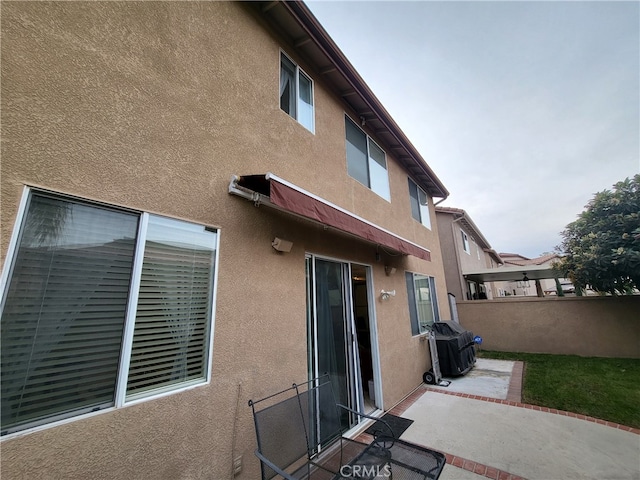 rear view of property featuring a patio area