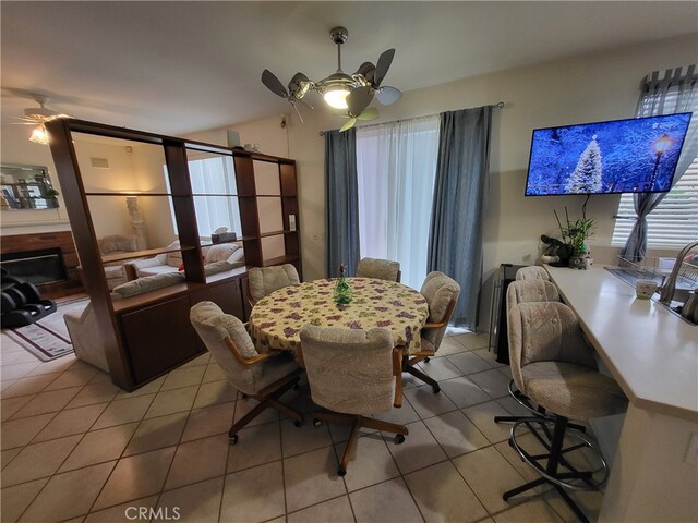 dining area featuring ceiling fan and light tile patterned flooring