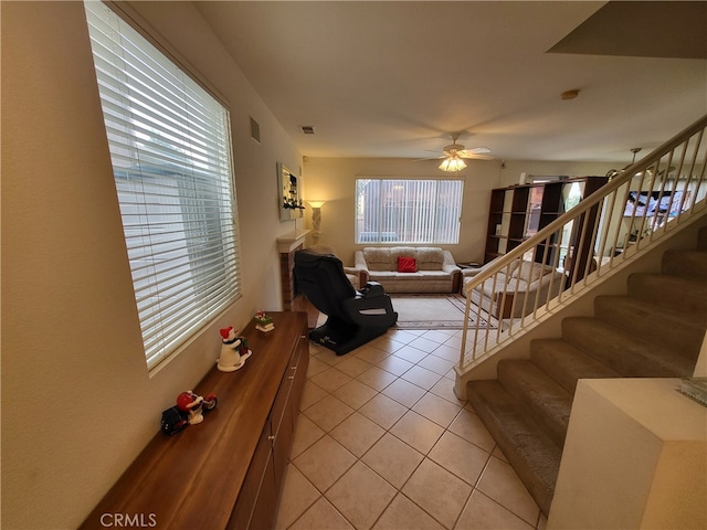 living room with light tile patterned floors and ceiling fan