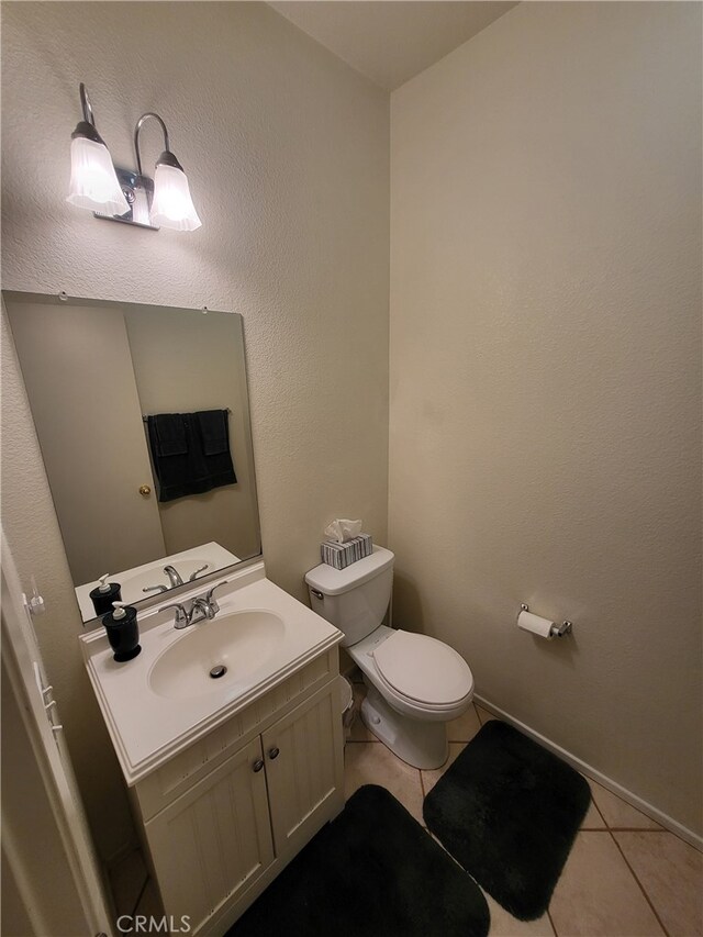 bathroom with tile patterned floors, vanity, and toilet