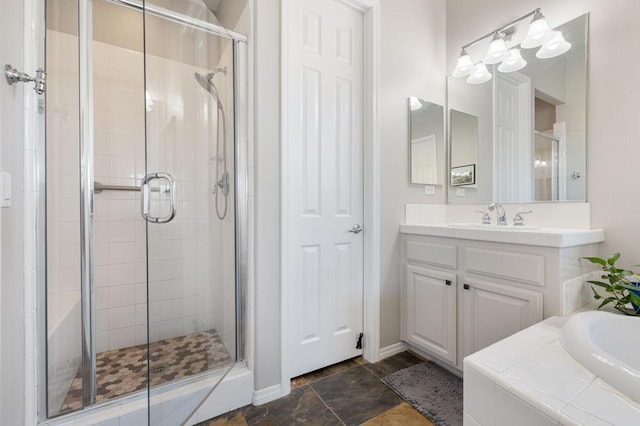 bathroom with vanity and shower with separate bathtub