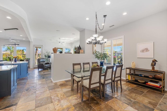 dining area with ceiling fan with notable chandelier