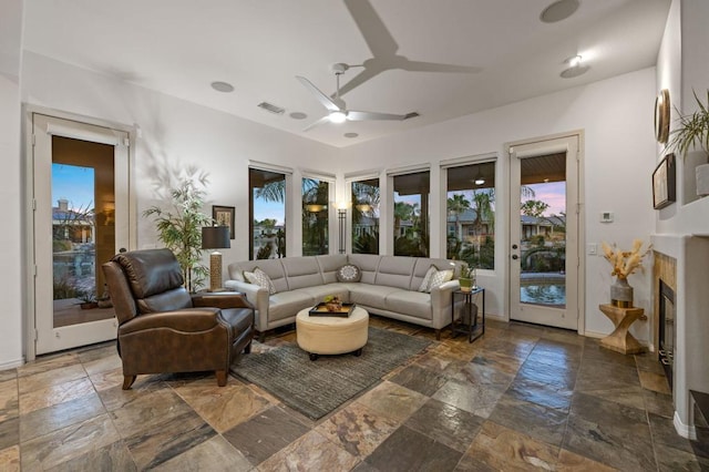 living room with a wealth of natural light and ceiling fan