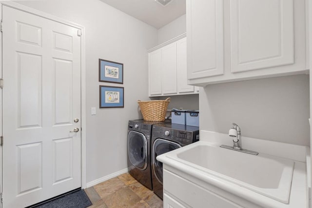 clothes washing area with cabinets, independent washer and dryer, and sink