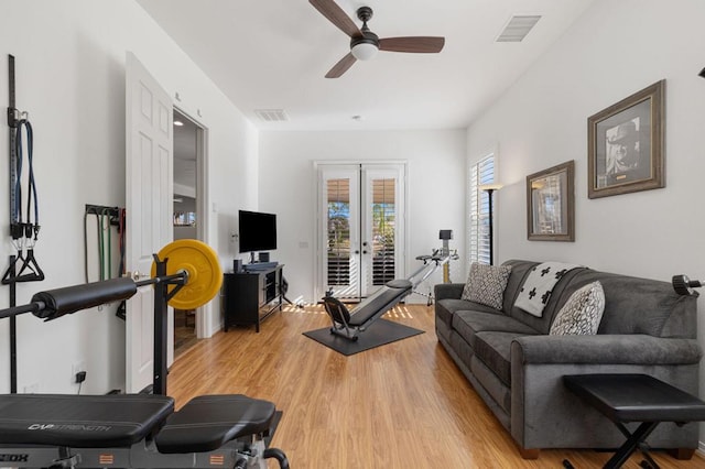 exercise room featuring french doors, ceiling fan, and light wood-type flooring