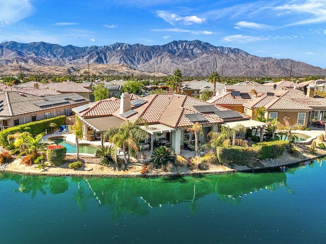 aerial view featuring a water and mountain view