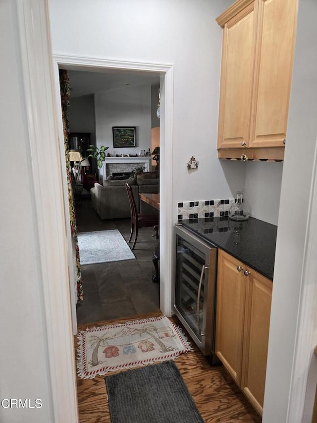 kitchen featuring light brown cabinets, dark hardwood / wood-style flooring, and wine cooler