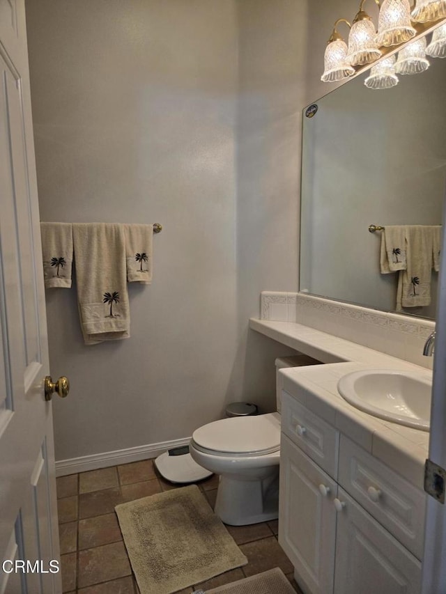 bathroom with tile patterned floors, vanity, and toilet