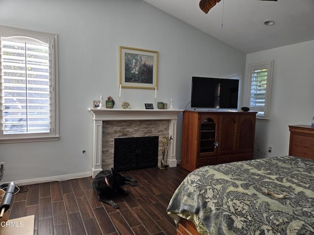 bedroom with multiple windows, dark hardwood / wood-style flooring, and lofted ceiling