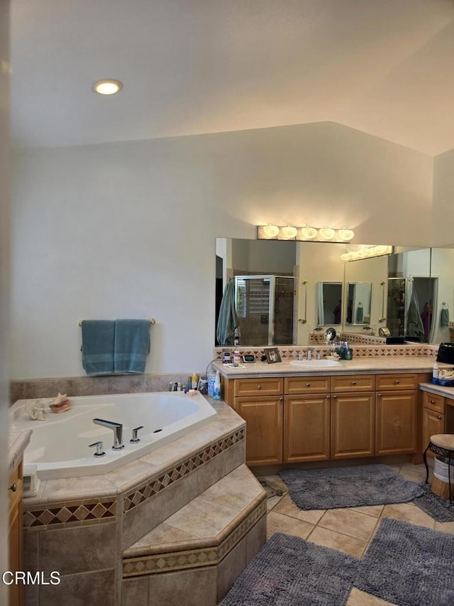 bathroom featuring tile patterned floors, vanity, and shower with separate bathtub