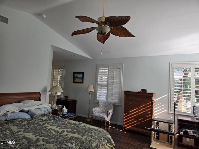 bedroom featuring ceiling fan, dark wood-type flooring, and lofted ceiling