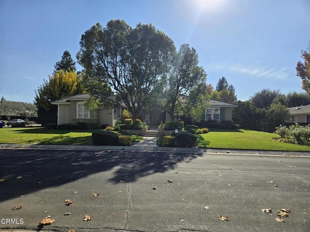 single story home featuring a front yard