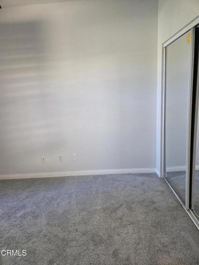 unfurnished bedroom with carpet flooring and a closet