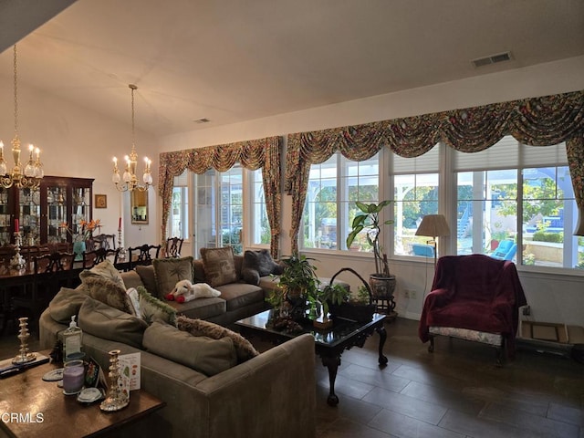 living room with plenty of natural light and an inviting chandelier