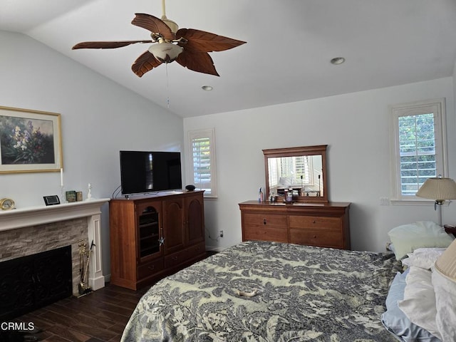 bedroom featuring multiple windows, ceiling fan, dark hardwood / wood-style floors, and vaulted ceiling