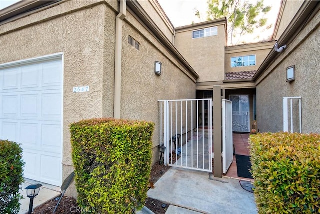 entrance to property featuring a garage