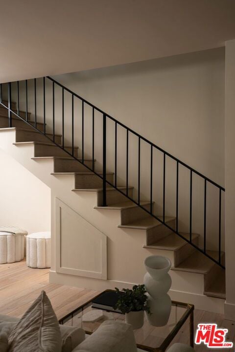 stairs featuring wood-type flooring