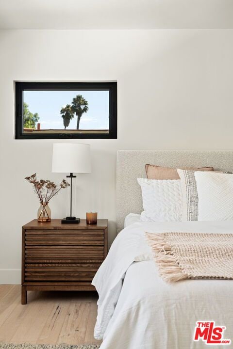 bedroom featuring light hardwood / wood-style floors and multiple windows