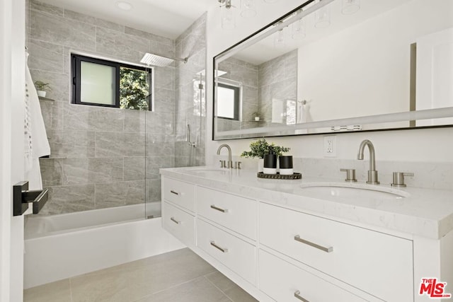 bathroom featuring tile patterned flooring, vanity, and tiled shower / bath combo