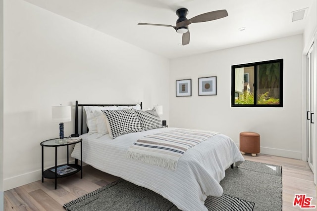 bedroom featuring light wood-type flooring and ceiling fan