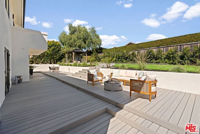 deck with a gazebo and an outdoor living space with a fire pit