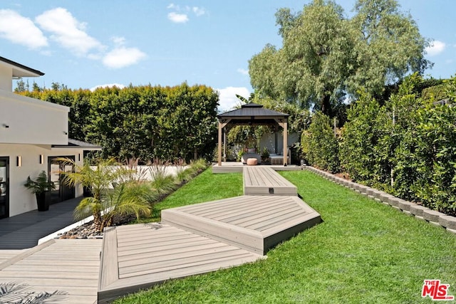 view of yard with a gazebo and a wooden deck