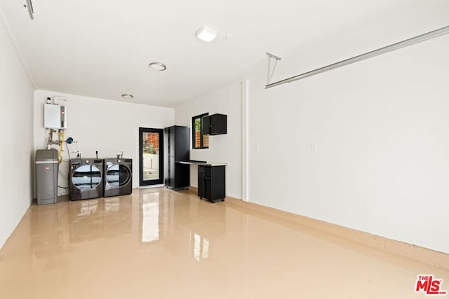 interior space with water heater and washer and clothes dryer