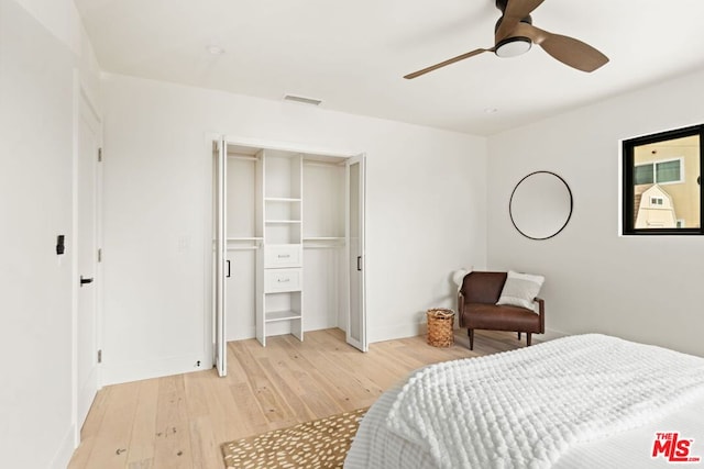 bedroom featuring light wood-type flooring, a closet, and ceiling fan