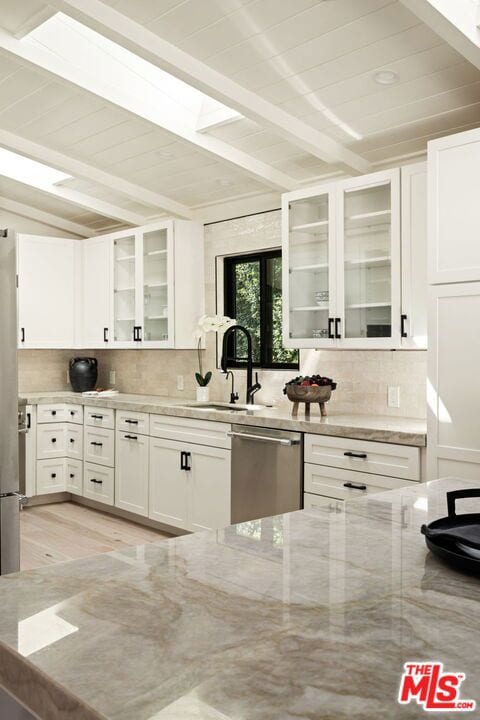 kitchen featuring dishwasher, light wood-type flooring, white cabinetry, and light stone counters