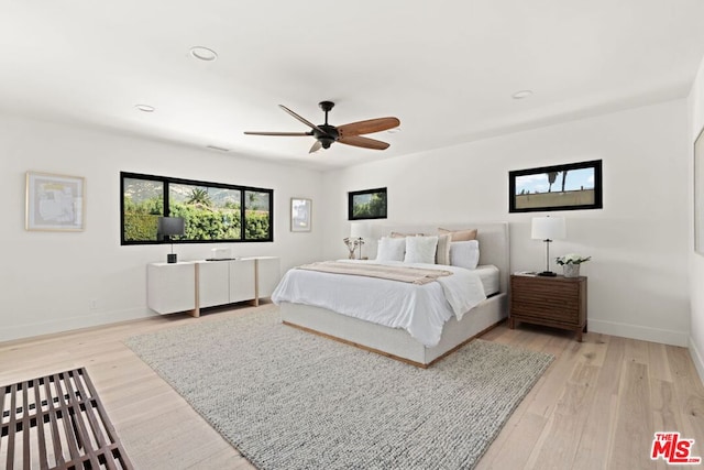 bedroom featuring light wood-type flooring and ceiling fan