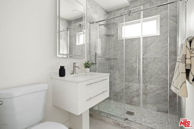 bathroom with vanity, toilet, and an enclosed shower