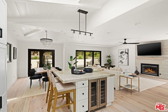 kitchen featuring white cabinets, french doors, light wood-type flooring, and hanging light fixtures