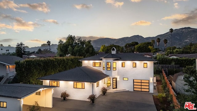 view of front of home with a mountain view and a garage