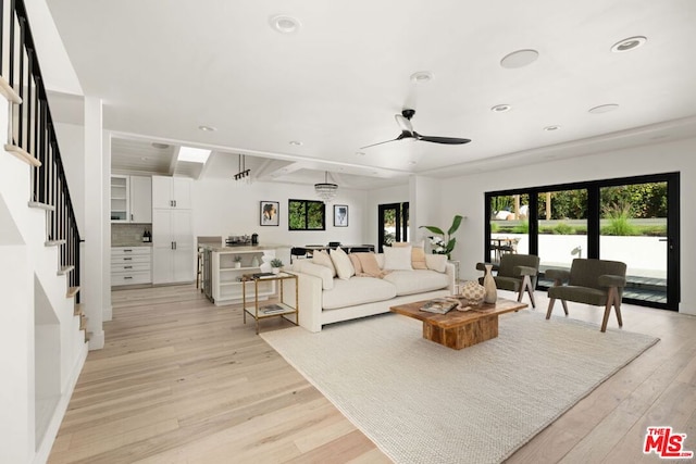 living room with ceiling fan and light hardwood / wood-style floors