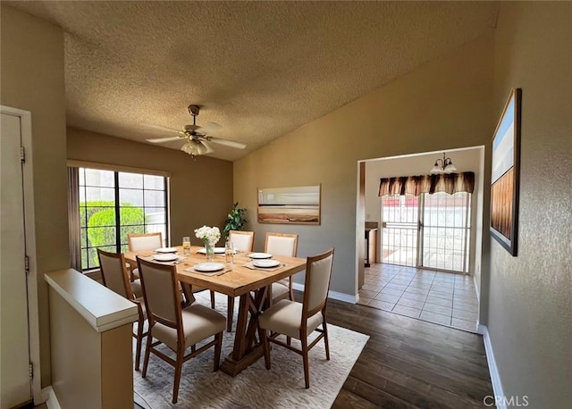 dining area with vaulted ceiling, a wealth of natural light, ceiling fan, and dark hardwood / wood-style floors