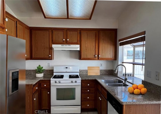 kitchen with sink, dark stone counters, and appliances with stainless steel finishes