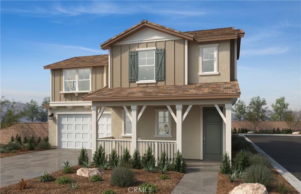 view of front of home featuring a porch and a garage