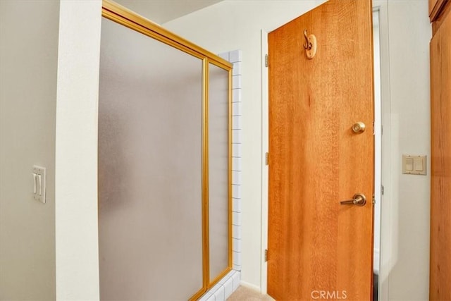 bathroom featuring an enclosed shower