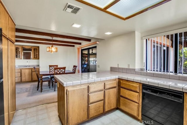 kitchen with kitchen peninsula, decorative light fixtures, beamed ceiling, dishwasher, and tile counters