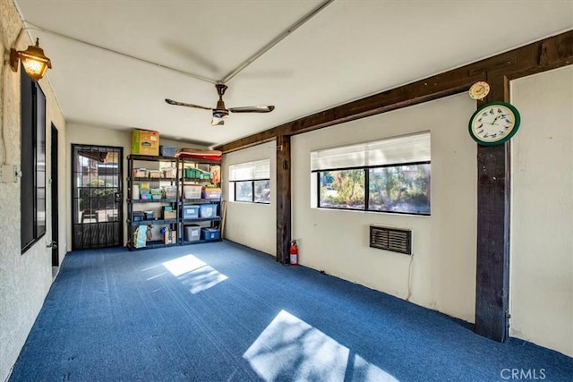 interior space with ceiling fan and carpet floors