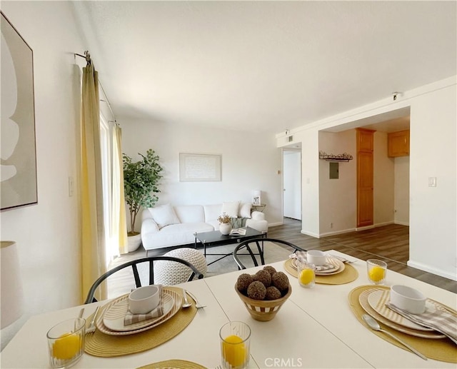 dining area with dark wood-type flooring