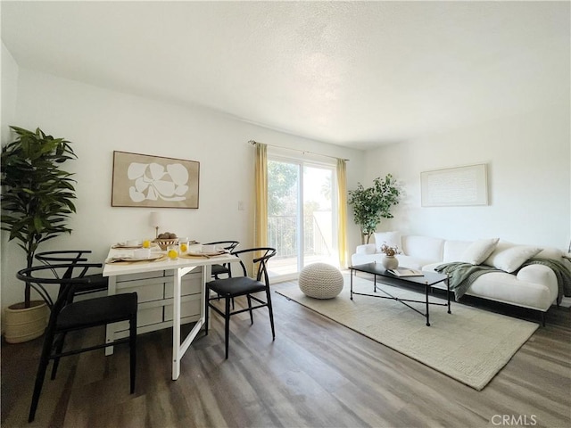 living room featuring breakfast area and hardwood / wood-style flooring