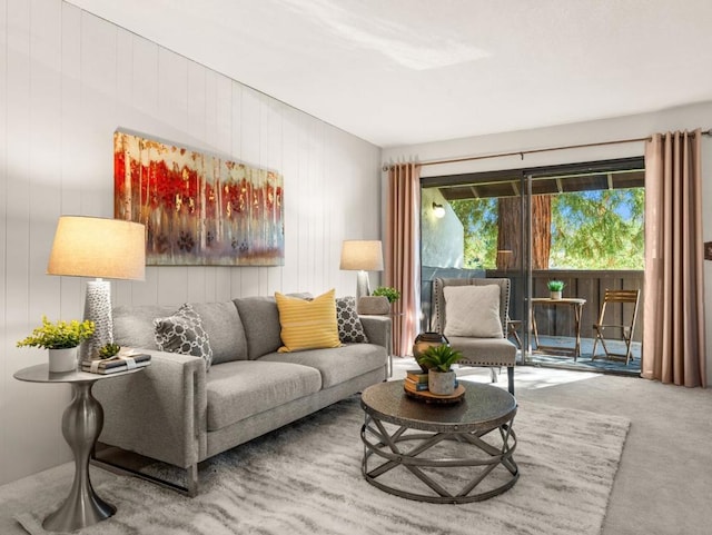 living room featuring carpet flooring and wood walls