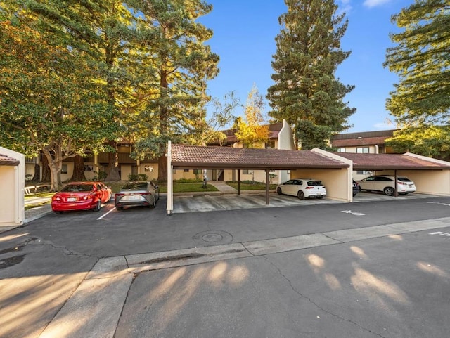 view of parking / parking lot featuring a carport