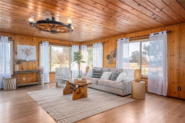 sunroom / solarium featuring wood ceiling and a notable chandelier