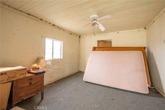 unfurnished bedroom with dark carpet and ceiling fan