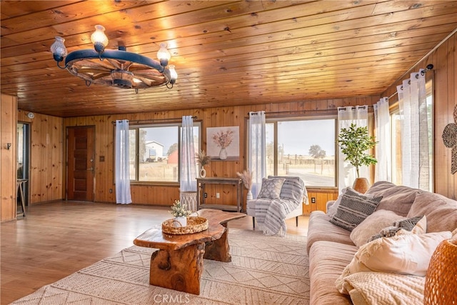 living room featuring wood ceiling, wooden walls, and light hardwood / wood-style floors