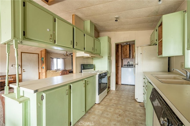 kitchen with sink, white range, lofted ceiling, washer / dryer, and dishwashing machine