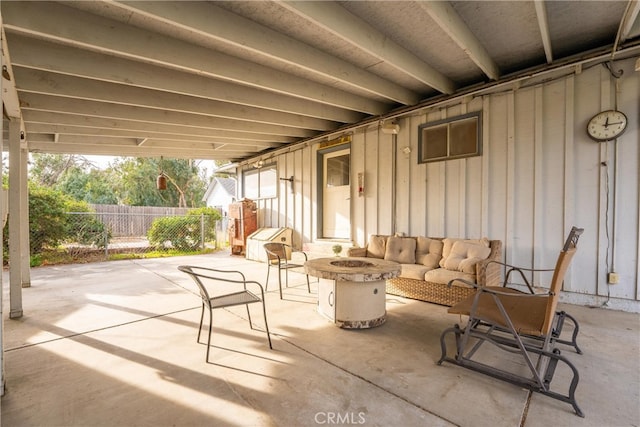 view of patio with an outdoor living space with a fire pit